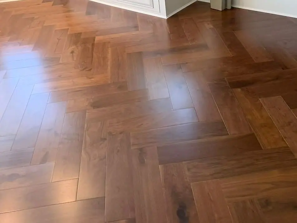 Close-up of a polished walnut herringbone floor